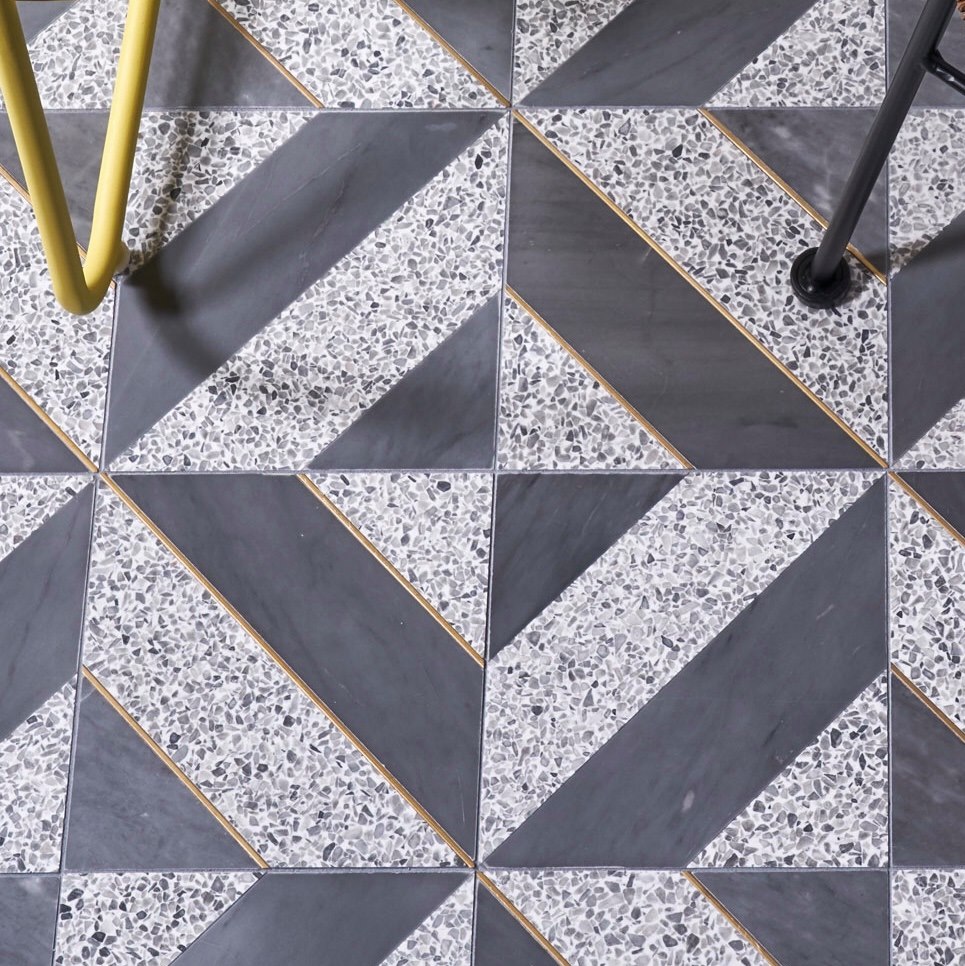 colorful shadow terrazzo and brass tile floor design