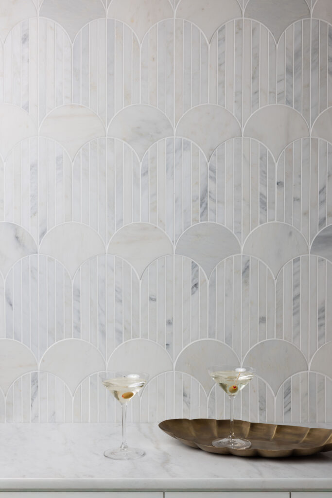 Linear mosaic with solid and patterned white tiles for backsplashes or walls.