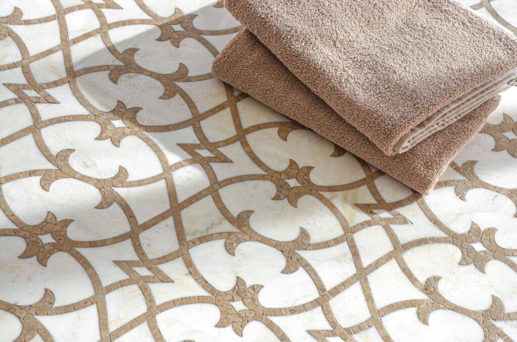Delicate white mosaic tile featuring embroidered-style geometric patterns.