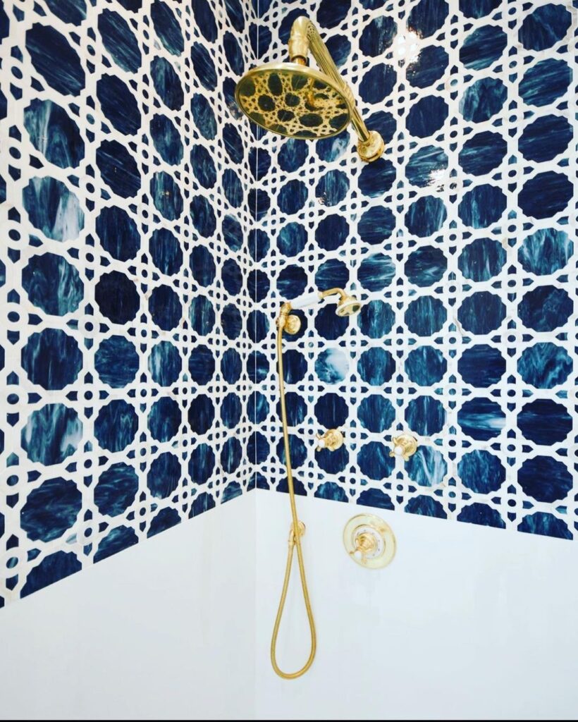 Shower wall with reflective sapphire blue glass tiles